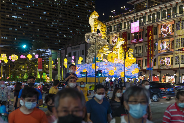 People wearing face masks before Year of the Tiger decorations in Chinatown, Singapore