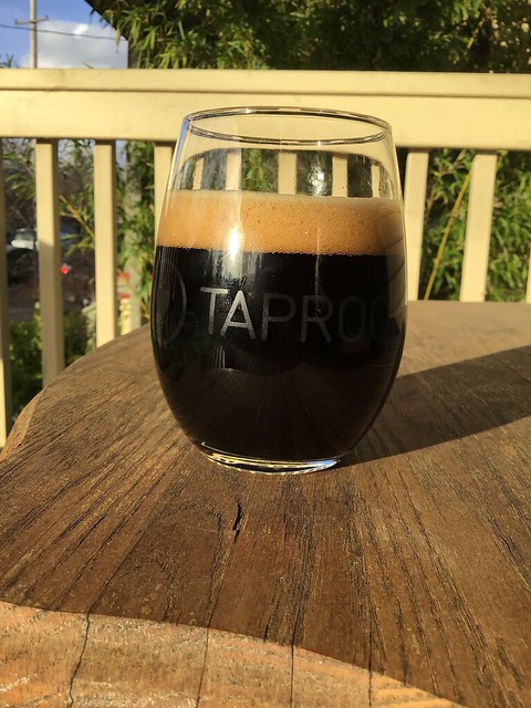 Wander brewing's Correspondent foreign export stout in glass on table, outside