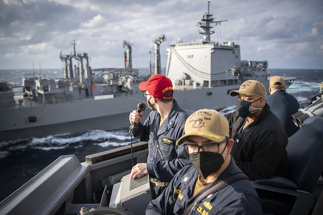 Officers aboard USS Dewey (DDG 105) supervise a replenishment-at-sea with the JMSDF replenishment ship JS Oumi (AOE 426) in the Philippine Sea.