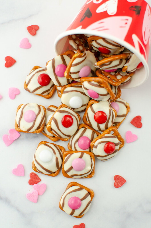 Overhead shot of Valentine's Day pretzel hugs with red and pink heart sprinkles