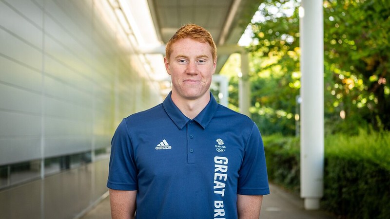 Tom Dean stood at the front of the Sports Training Village, wearing a navy Team GB polo shirt.