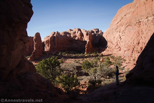 Looking back through the gap on the Primitive Windows Trail to rock formations, Arches National Park, Utah