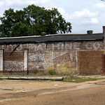 Multiple Ghost Signs - Hattiesburg, MS This abandoned business is located along E. Pine St., where US11 travels east from downtown Hattiesburg.

Along the top is the name ouf the business, which includes Auto Machine Co. Along the front in green squares are the names of auto part manufacturers the mechanic used.

In all of this, I think I also see more than two layers of Royal Crown Cola ads.