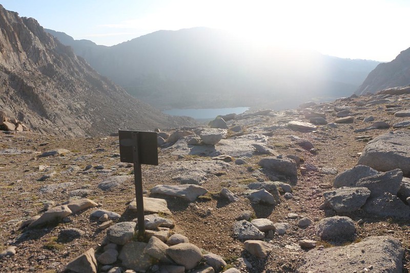 The Entering Sequoia National Park sign at Old Army Pass in the blazing light, with Cottonwood Lake Number Five, below