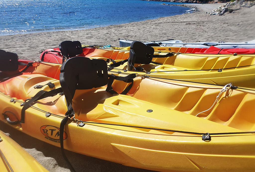 A close-up of a couple of yellow kayaks on the beach