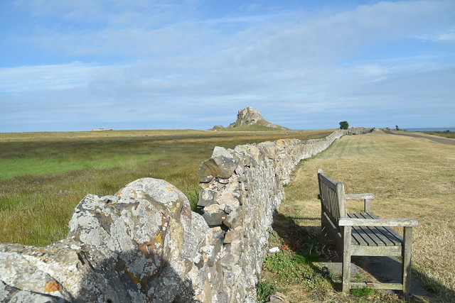 long stone wall and a bench