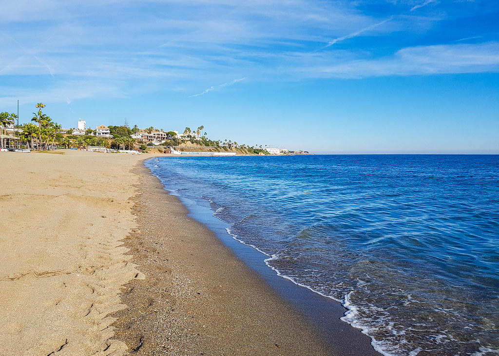 The beach in La Cala. The photo was taken in winter so there is nobody on the beach, but the sky is still blue. The sea is on the right hand side of the photo.