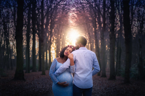 couple pregnant pregnancy woods sunset winter dark light backlight longdress belly hug