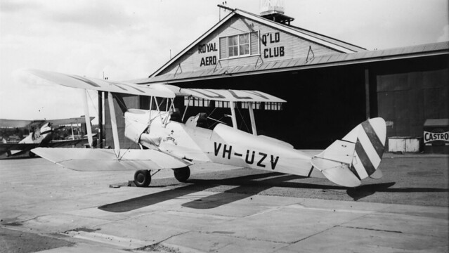 VH-UZV, a Tiger Moth, outside the Royal Queensland Aero Club hangar