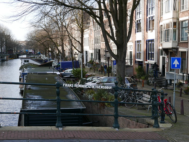 Old brick bridge over the canal Prinsegracht where the canal is crossing river Amstel - in Amsterdam city; free urban photo by Fons Heijnsbroek, 2022.