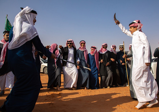 Saudi men dancing in line during King Abdul Aziz Camel Festival, Riyadh Province, Rimah, Saudi Arabia