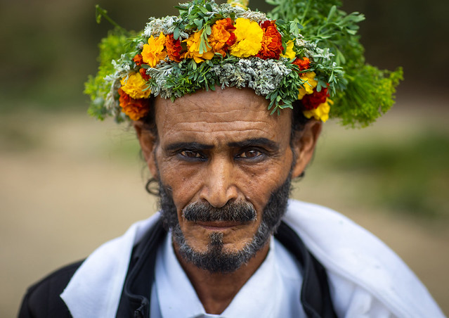 Portrait of a flower man with a floral crown on the head and kohl on his eyes, Asir province, Sarat Abidah, Saudi Arabia