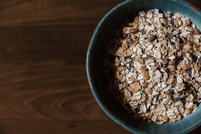 cereal flakes in blue bowl on wooden table