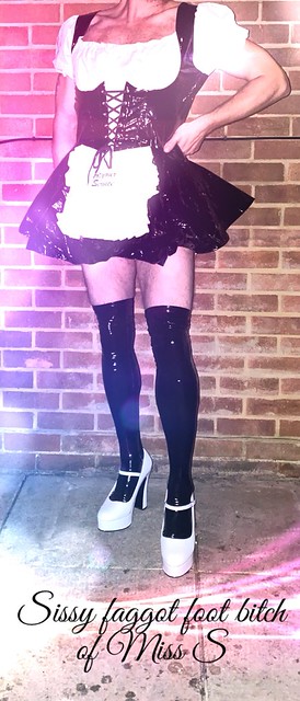 Sissy mincing in the garden in maids dress and heels