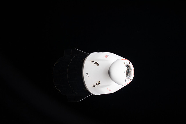 The bright, white pressurized capsule of the SpaceX Cargo Dragon