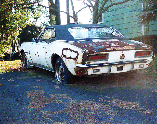 I always felt sorry for this 1967 Chevy Camaro sitting on grass about 5 miles from my house. Every time I passed by, it just got rustier. In winters, it was covered with snow and ice. The car never moved an inch in 10 years. Pearl River NY. May 2002.