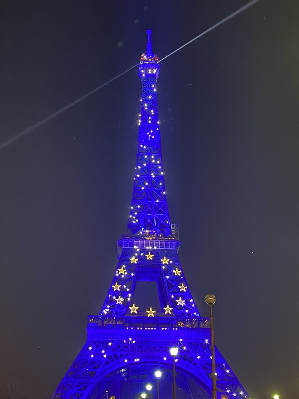 The Eiffel Tower lit up blue with gold stars in a circle to resemble the flag of Europe.