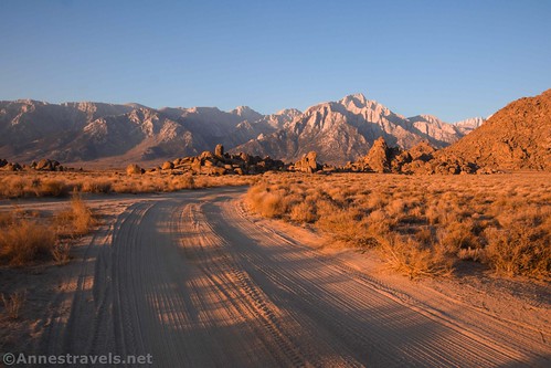 A dirt road at sunrise with views toward Lone Pine Peak and the Sierras, Alabama Hills National Scenic Area, California