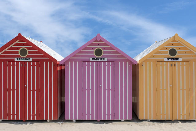 Red, pink and yellow beach huts