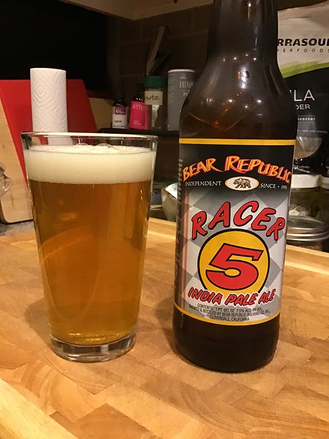 Bear Republic's Racer 5 IPA bottle next to a glass, in kitchen