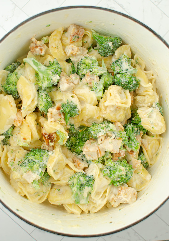 A pot of chees tortellini with chicken and broccoli in a creamy saucce