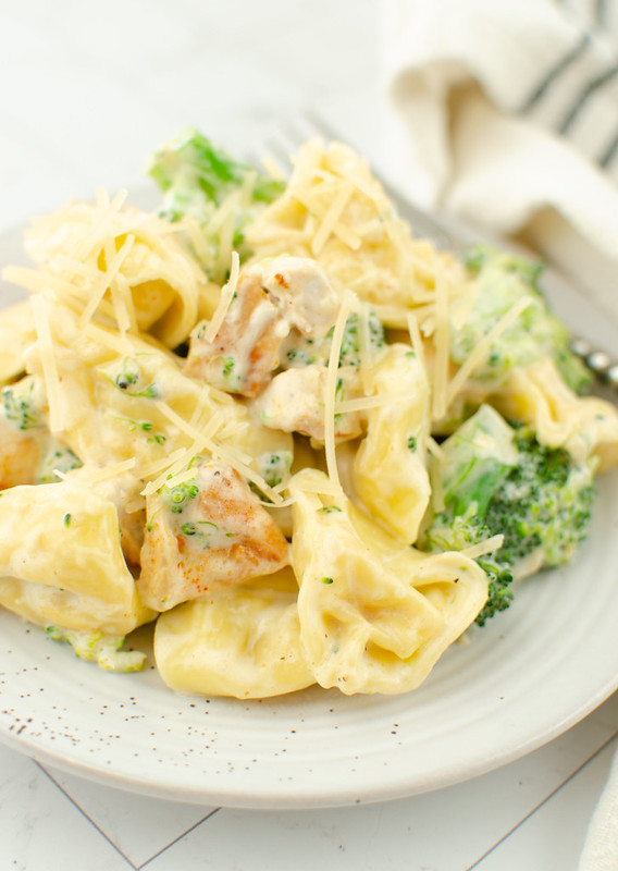 Cheese tortellini with cihcken and broccoli in a creamy sauce with Parmesan on top