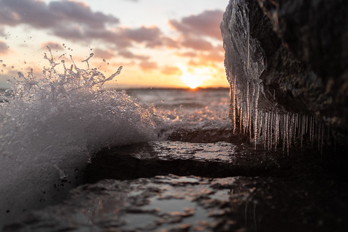 winter cold frozen ice wave splash water sunset clouds shore lakeontario