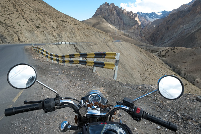 Looking over the handlebars of my rented Royal Enfield Bullet on the Srinagar-Leh Highway, approaching Fatula Top pass.