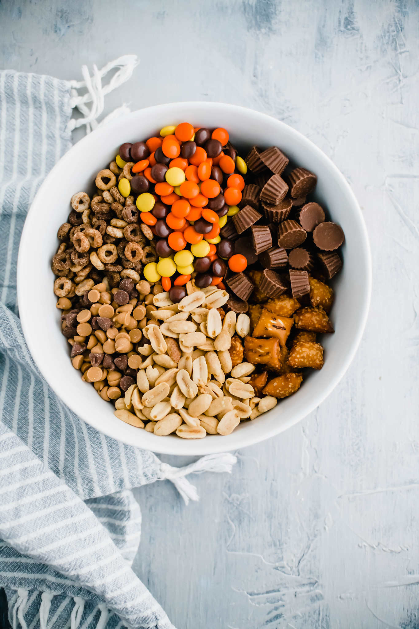 Ingredients for peanut butter trail mix in a bowl.