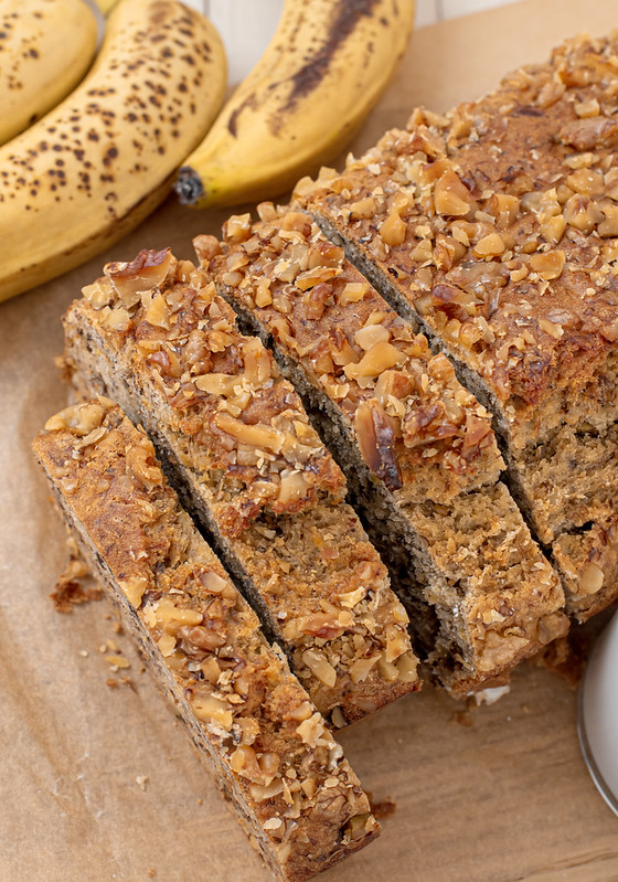 Overhead shot of sliced banana bread with nuts on top