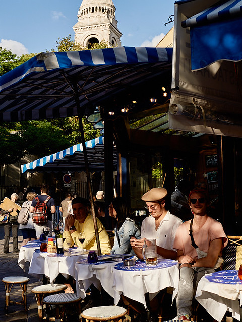 People sat at the terrace of a restaurent in Montmartre, Paris, France
