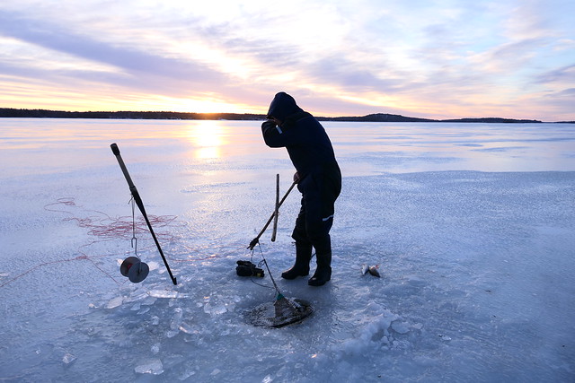 Ice fishing at sunrise