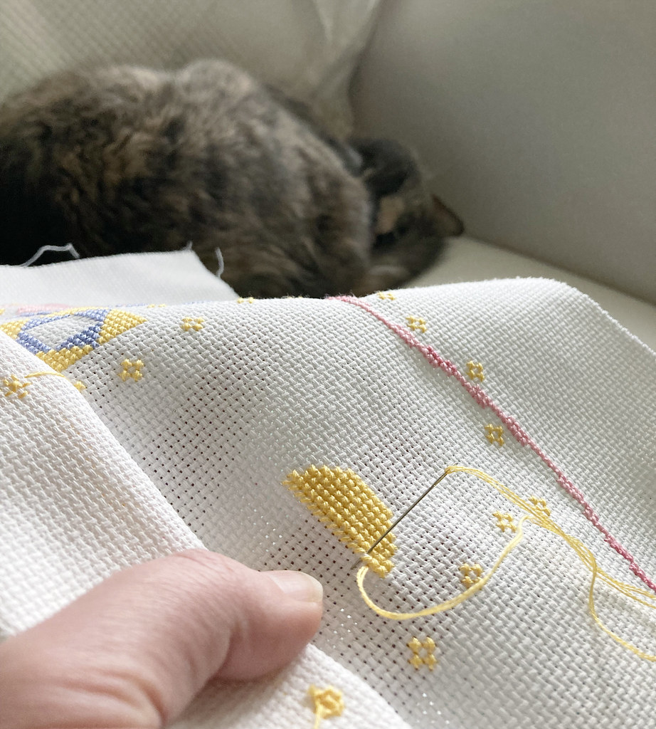 Stitching Les the Lion with Darcy the Cat