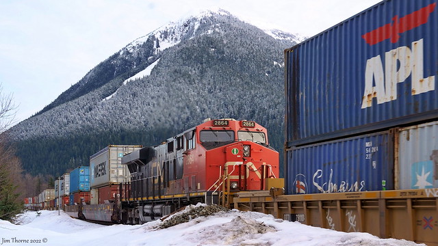 CN 2864 is the mid-train power on an east bound stack passing by the siding at Kwinitsa, mile 47.5 Skeena Sub - 1 February 2022 [© WCK-JST]