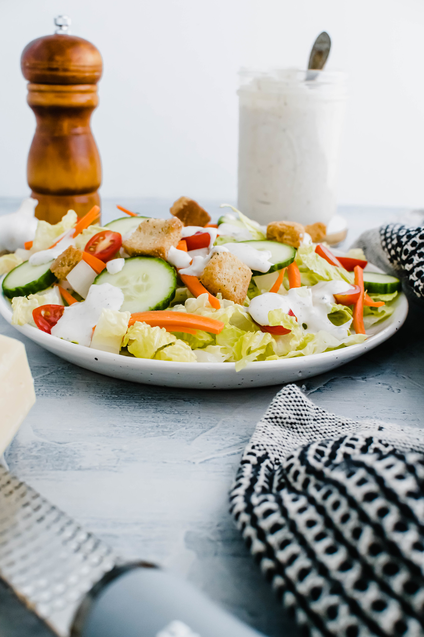 Salad of romaine, cucumbers, carrots, halved cherry tomatoes and croutons drizzled with parmesan peppercorn dressing.