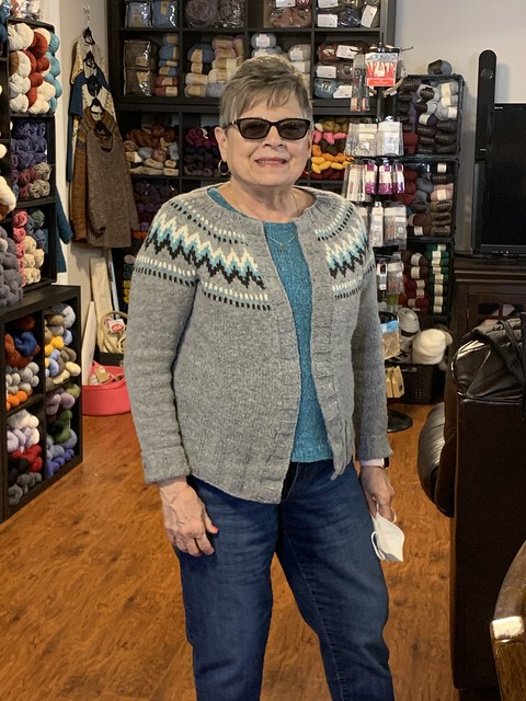 Bev is wearing her The Throwback by Sndrea Mowry knit using Navia Faroese Sock over a tee knit using Berroco Remix Light.