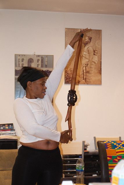 DSC_0775 Dee from Botswana White Top Black Pants and Hat Exercising with African Walking Stick Shoreditch Studio London
