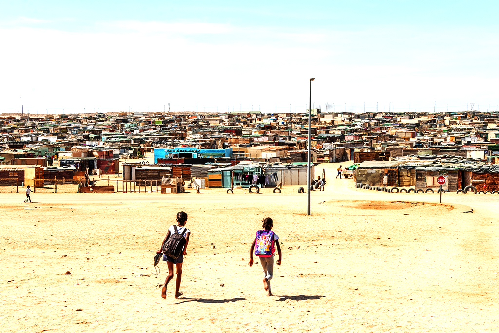 Two schoolgirls heading towards Democratic Resettlement Community on 2-23-22--Swakopmund copy
