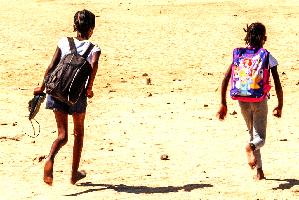 Two schoolgirls heading towards Democratic Resettlement Community on 2-23-22--Swakopmund (detail) copy