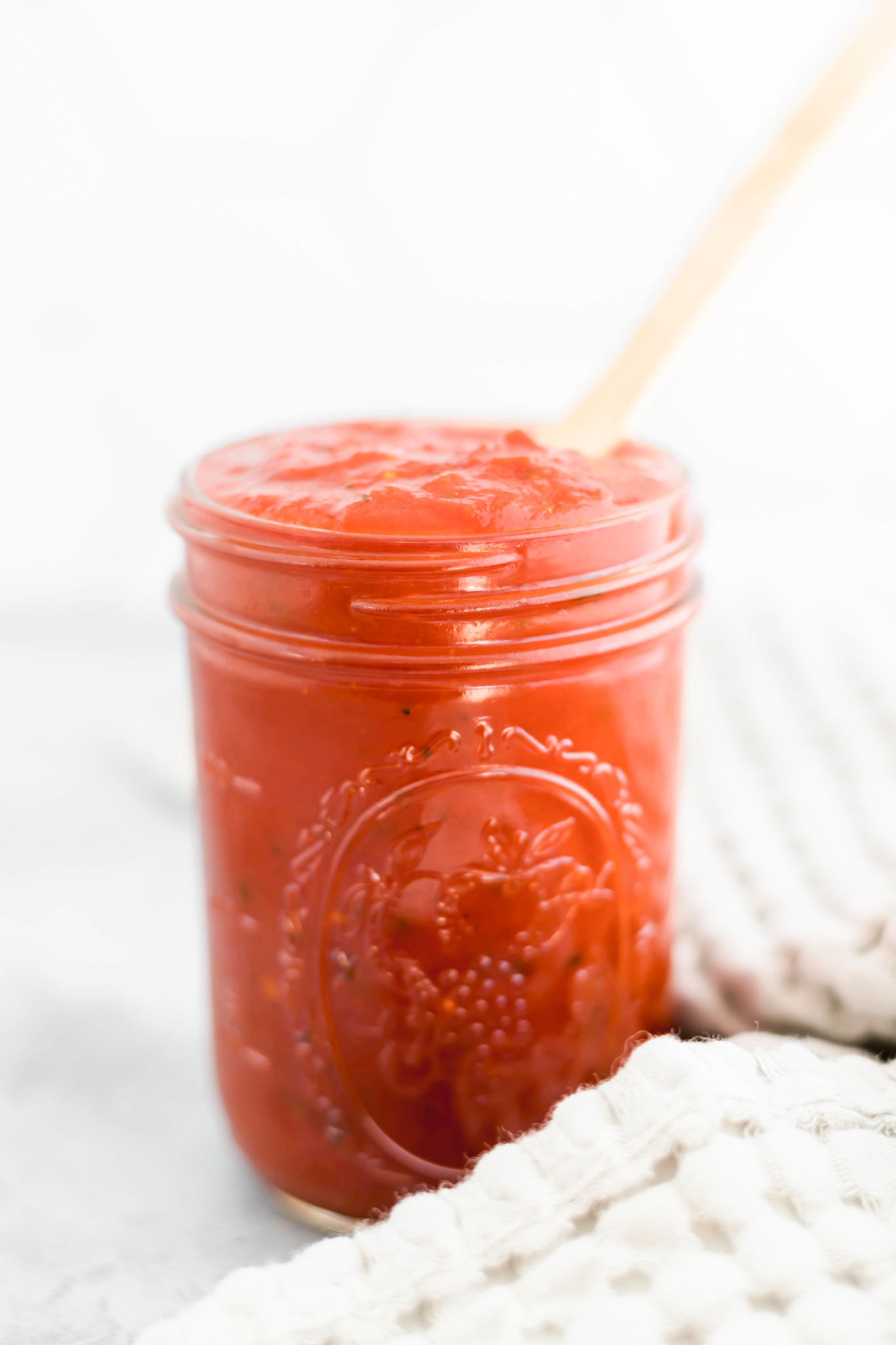 Mason jar filled with pizza sauce.