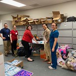 2020-02-19: Yareli demonstrating to the team how to fold shirts Marie Kondo-style at Houston Children's Charity!