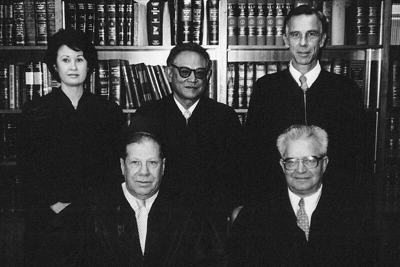 Guam Judges, 1980. Standing from left to right: Janet Weeks, Joaquin Manibusan, and Richard Benson. Seated are Paul J. Abbate, Jr. and John P. Raker. Guam Public Library System Collection