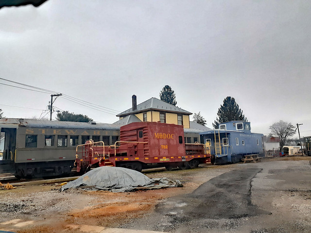 Rail Cars And A Blue Caboose.