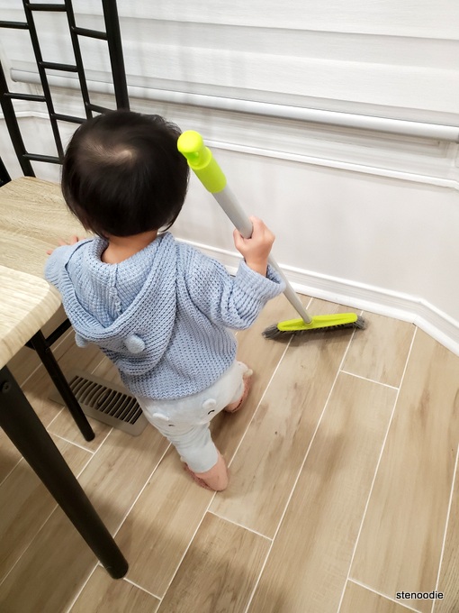  Toddler holds broom
