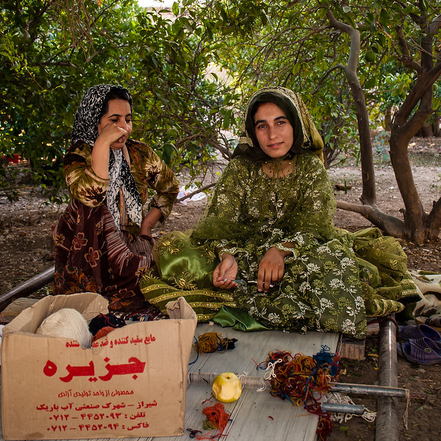 Qashqai sisters weave a carpet on a floor loom, Firuzabad, Iran