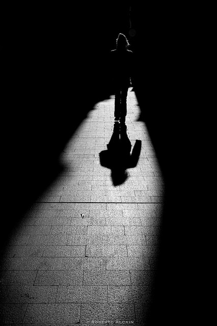 Woman walking in the shadows