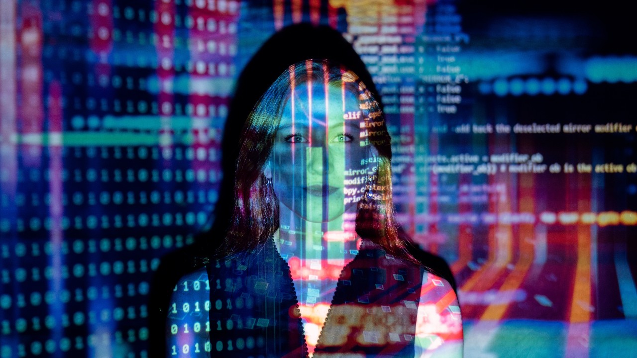 A woman with lines of code projected across her face