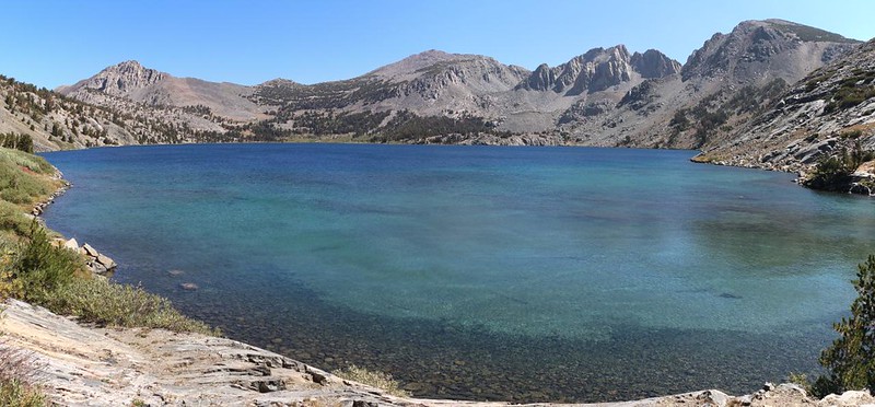 Panorama view of the clear waters of Duck Lake, with Duck Lake Pass (far left) and Duck Lake Peak (right)