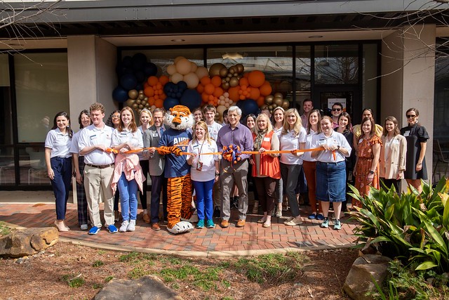 A group of people at a ribbon cutting.