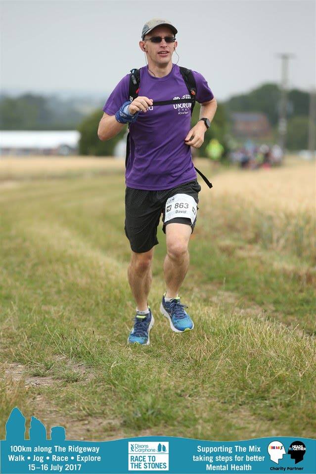 Male wearing purple and black, running